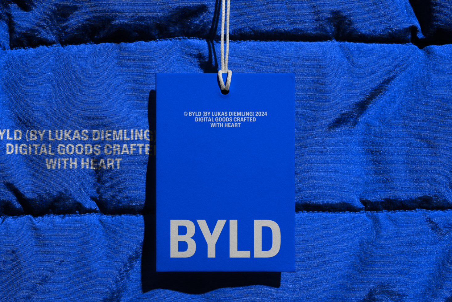 Blue tag mockup for branding with text design on a textured fabric background, ideal for designers looking to showcase logo or label designs.