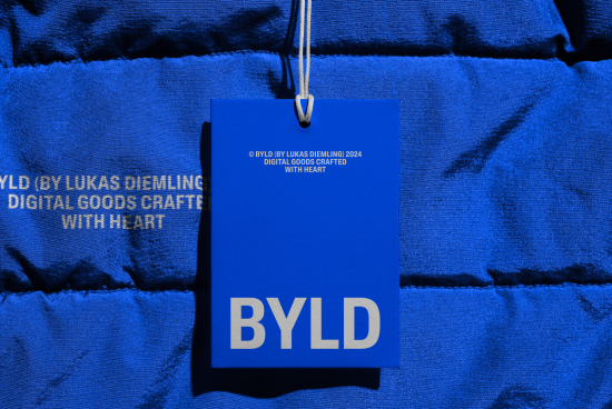 Blue tag mockup for branding with text design on a textured fabric background, ideal for designers looking to showcase logo or label designs.