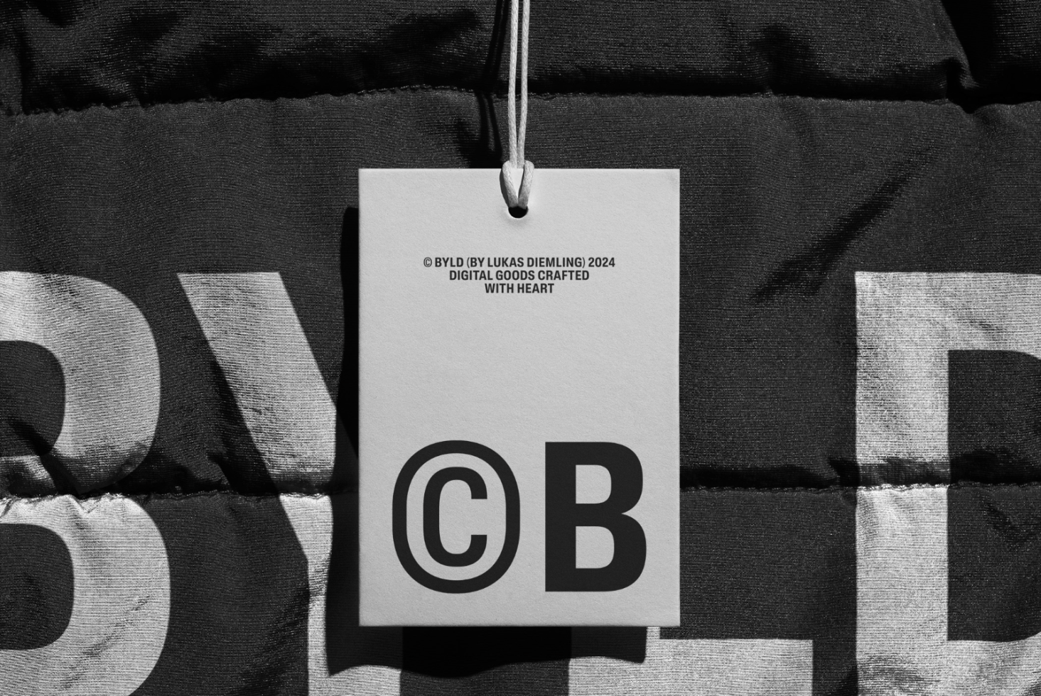High-contrast black and white mockup tag featuring bold CB logo design, textured background, ideal for showcasing brand identity.