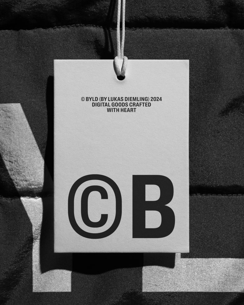Monochrome tag mockup hanging on fabric with bold typography, ideal for branding presentation, graphic design asset.