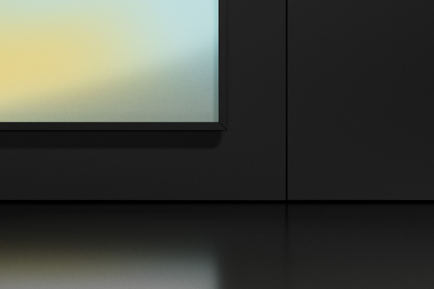 Minimalist monitor mockup with subtle gradient wallpaper on sleek black desk for modern design presentations.