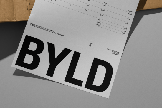Close-up invoice paper mockup with bold typography focus, realistic shadows, atop textured surface, ideal for font showcase or graphic design.