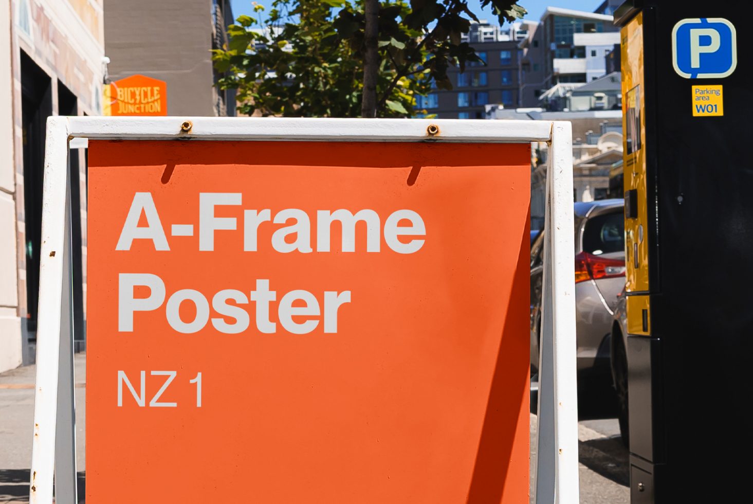 A-frame sidewalk poster mockup in urban setting, bright orange color for advertising and promotional design display.