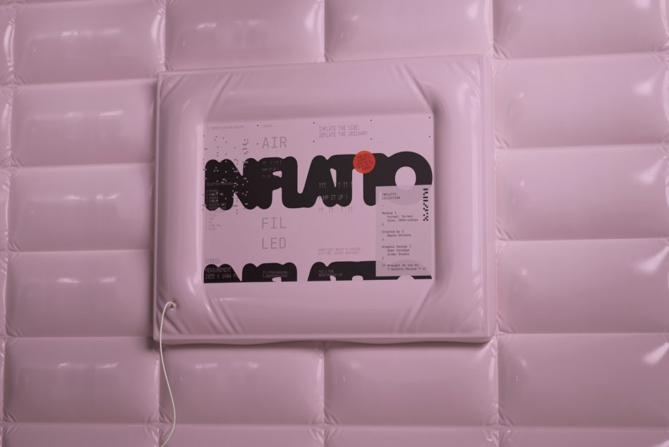 Poster mockup nested in pink bubble wrap packaging overhead shot