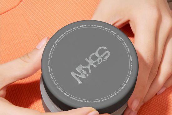 Close-up on cosmetic jar mockup held by female hands, clear branding space, beauty packaging design, editable template display.