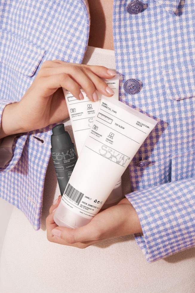 Hands holding labeled cosmetic tubes for branding mockup design, high-resolution product photography template.