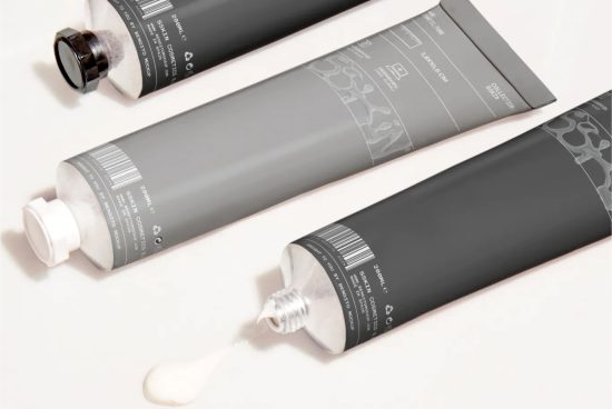Cosmetic tube packaging mockup with three tubes and spilled product, ideal for beauty and skincare design presentations.