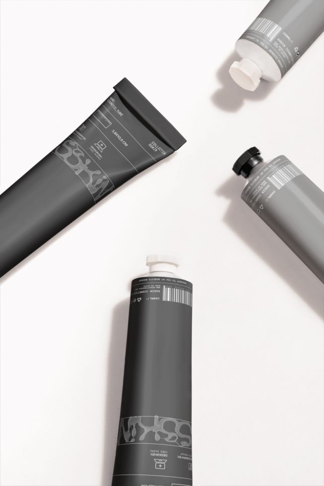 Elegant cosmetic tube packaging mockup with three different sized containers on a clean background, ideal for designers to showcase branding designs.