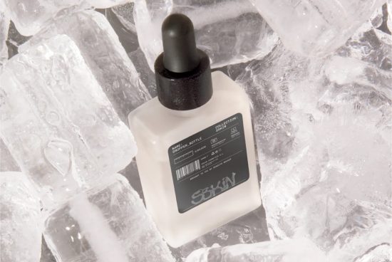 Cosmetic dropper bottle mockup surrounded by ice cubes, ideal for showcasing skincare product designs, packaging mockups, and branding visuals.