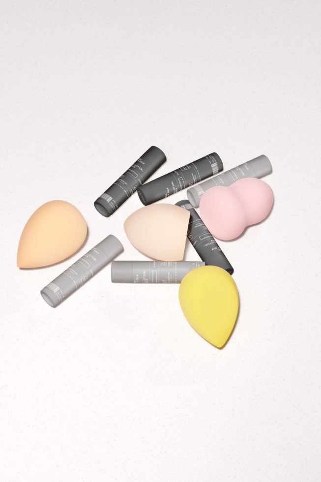 Beauty product mockup with makeup sponges and tubes on a clean background, perfect for branding, packaging, and advertising designs.