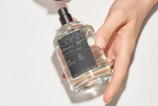 Perfume bottle mockup held by female hand on a light background, ideal for presentations and branding in the beauty industry.