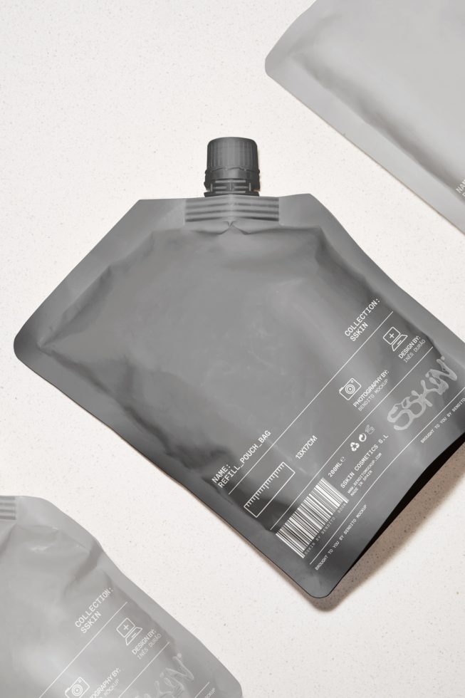 Empty gray refill pouch packaging mockup on a light textured background for product design, high-resolution, versatile, reusable.