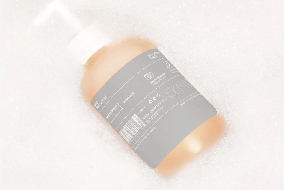 Mockup of a shampoo bottle with label design submerged in soapy water, ideal for presenting cosmetic branding and packaging designs.