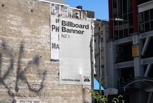 Urban billboard mockup on a weathered wall for outdoor advertising design showcase, with clear sky and buildings in backdrop.