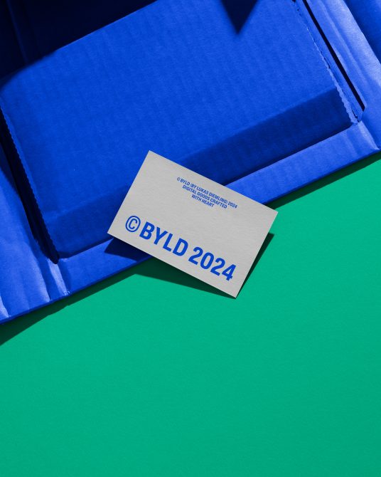 Creative business card mockup on blue textured paper with vivid green background, showcasing print design and branding.