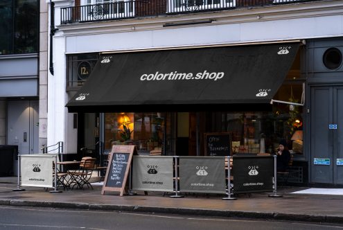 Street-level mockup of a store exterior with branded canopy and signage displaying the website colortime.shop, with sidewalk barriers.