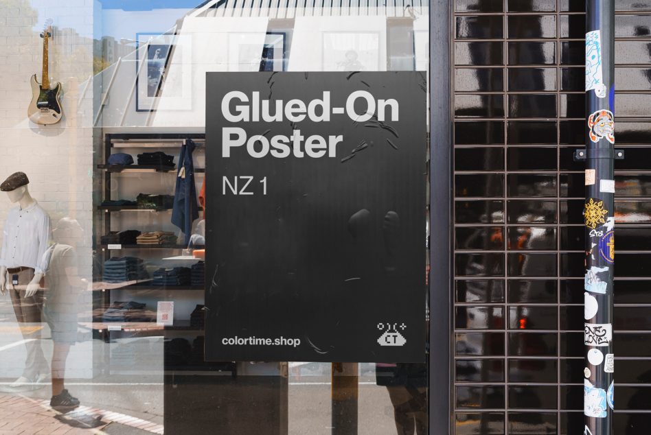 Glued-on street poster mockup with urban background, storefront, and stickers on pole, ideal for designers' realistic display presentations.