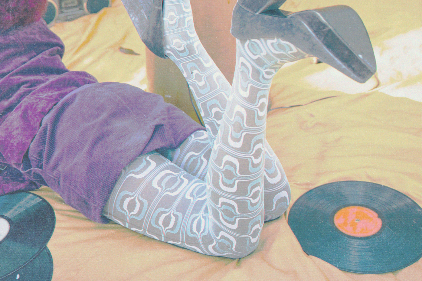 Retro styled photo featuring geometric pattern socks, vintage heels, vinyl records, ideal for mockup and graphic design resources.