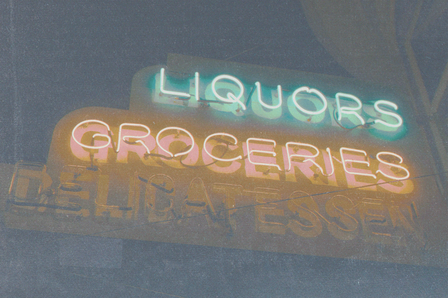 Vintage neon sign mockup with words LIQUORS, GROCERIES, DELICATESSEN in glowing typography ideal for retro design projects for designers.