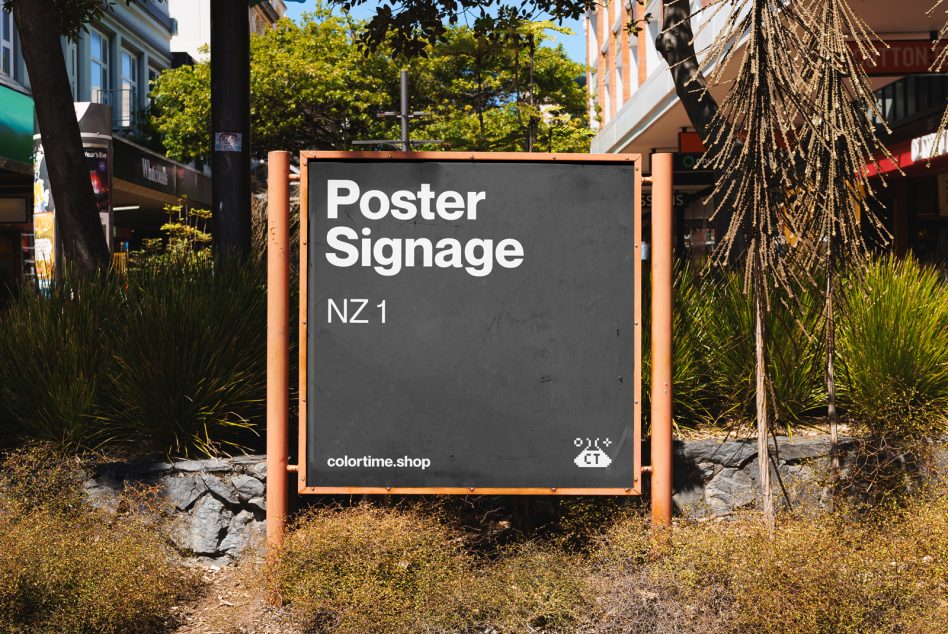 Outdoor poster signage mockup in an urban setting surrounded by plants and a clear sky, ideal for realistic advertising presentations by designers.