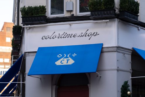 Exterior storefront mockup with signage, blue awning featuring pixel design, suitable for branding and retail design visuals.