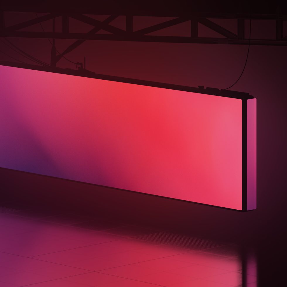 Large billboard mockup with neon pink and purple gradient in an industrial setting for advertising design presentation.