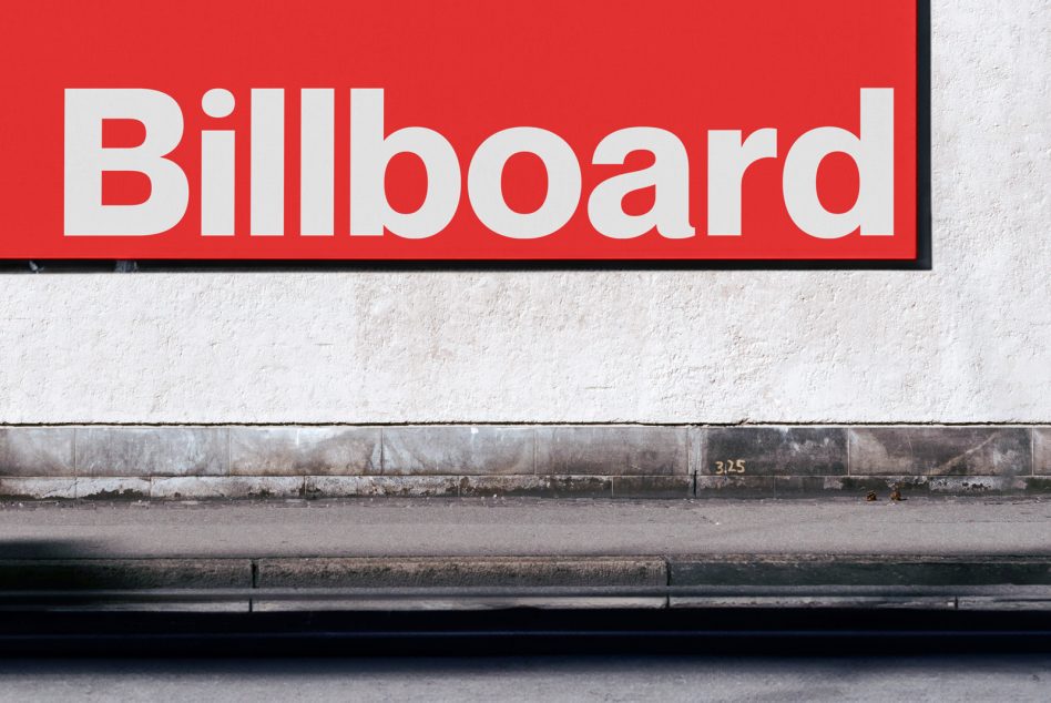 Bold red billboard sign with white sans-serif text on weathered concrete wall