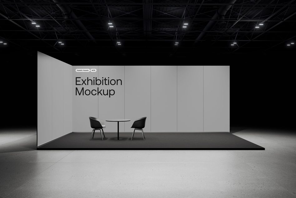 Professional exhibition stand mockup in a dark hall with spotlighting, featuring a minimalist design desk and chairs, ideal for display presentations.