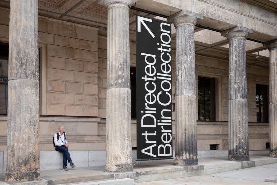 Person sitting by a museum entrance with Art Collection banner, ideal for mockup templates in cultural and historical design contexts.