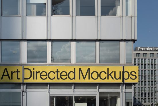 Modern urban building facade with yellow signage displaying 'Art Directed Mockups', ideal for mockup design inspiration.