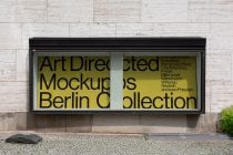 Black storefront window with yellow overlay tint, Berlin Collection mockup text visible