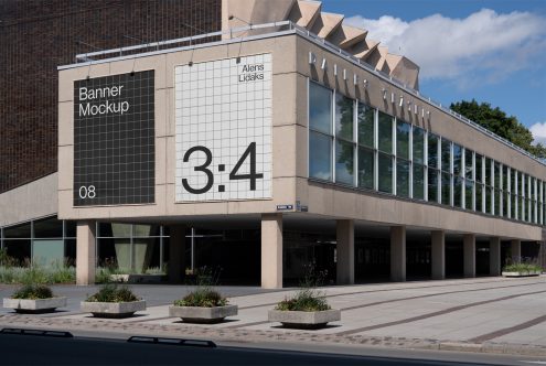 Urban outdoor banner mockup on building facade with clear sky, perfect for advertising design presentations to display graphics, posters, or ads.