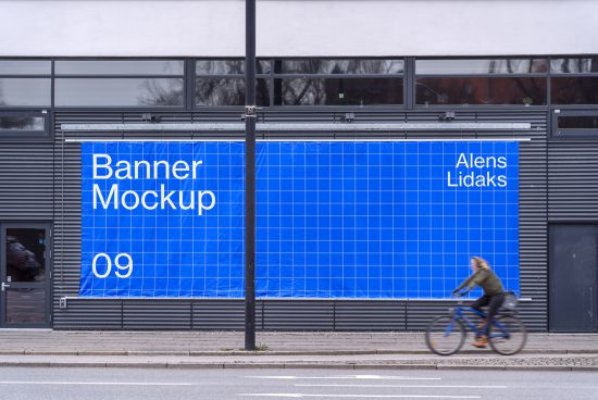 Outdoor banner mockup on building facade with cyclist passing by, urban advertising design, editable street marketing mockups template.