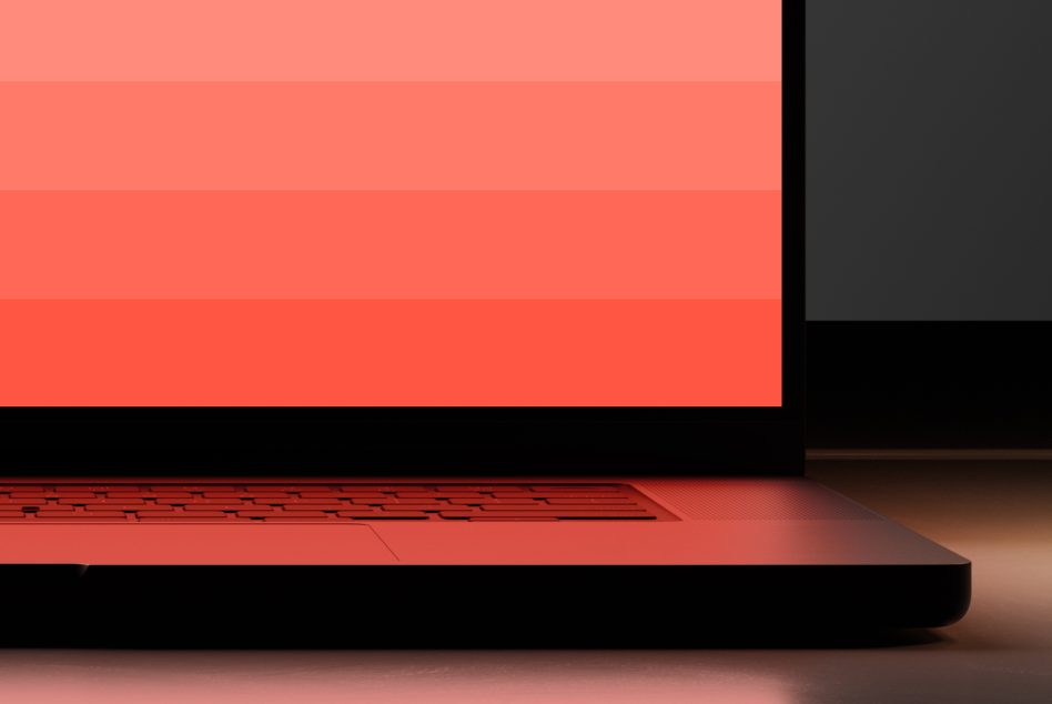 Stylish modern laptop mockup on minimalist desk with coral screen gradient, perfect for website design presentation or portfolio display.