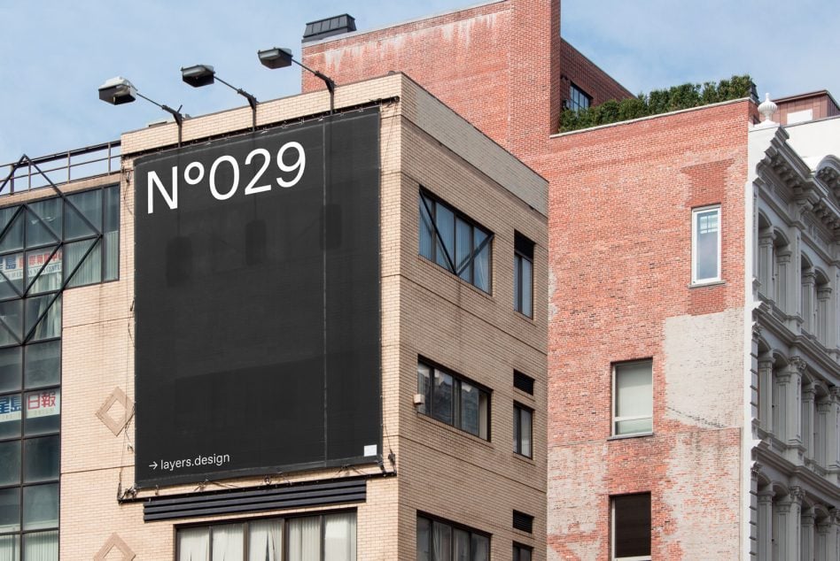 Dark billboard on brick building facade showing N°029 with street view