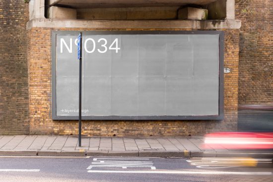 Blank urban billboard mockup on a brick wall with a blurred moving car, ideal for graphic design advertising mockups and templates.