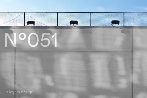 Urban wall and fence shadow for mockup, clean brick texture with typography overlay, minimalist design background.