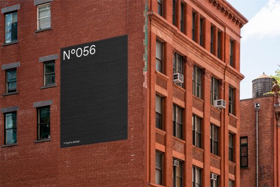 Urban building wall with a mockup black billboard for advertising design, clean textures, editable graphic design template.