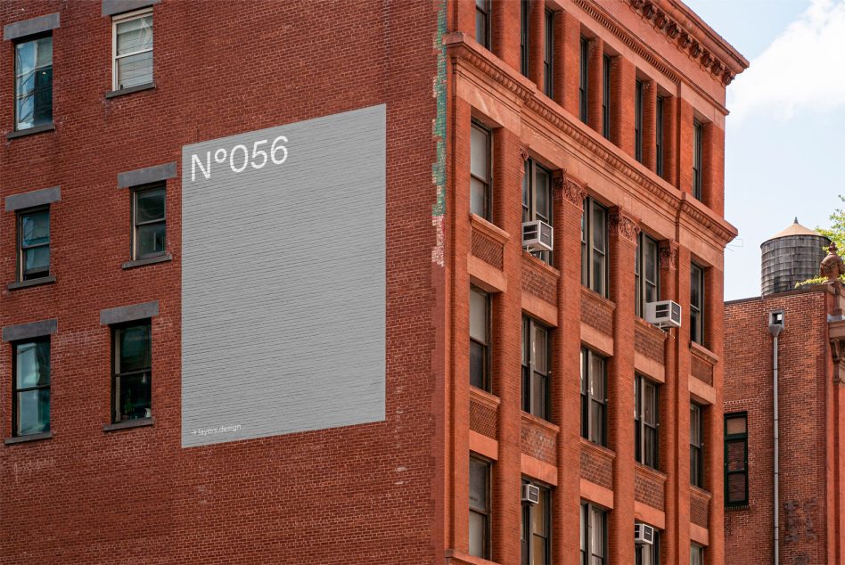 Urban billboard mockup on a brick building side, design asset for advertising, realistic outdoor ad space, clear sky, editable template.