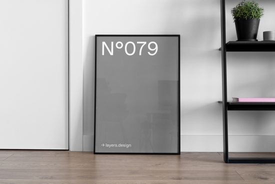 Minimalist poster frame mockup leaning against wall next to shelf with plant and books, ideal for presentation in a modern interior design context.