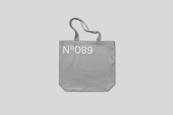 Gray tote bag mockup with elegant typography design isolated on white, suitable for branding presentations and digital assets.