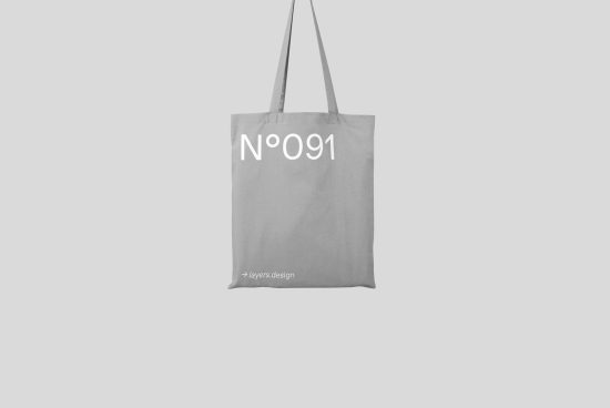Minimalist tote bag mockup with number design, isolated on a grey background, showcasing front view for fashion and retail projects.