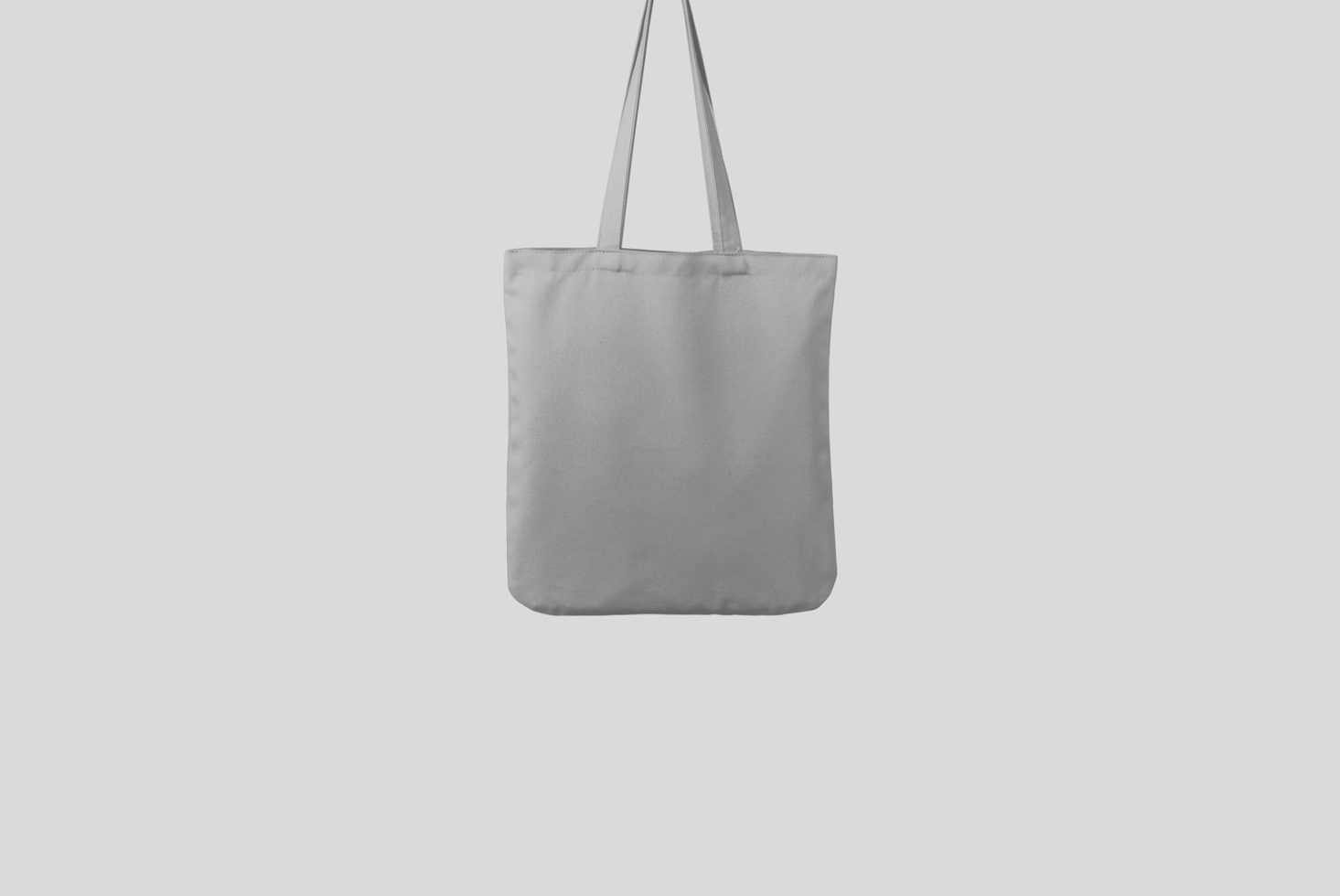 Blank tote bag mockup centered on a plain background, ideal for showcasing design patterns or branding graphics for portfolios.