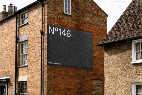 Vintage brick building with bold black graphic signage mockup, No 146, classic typeface, perfect for urban font presentations and signage templates.