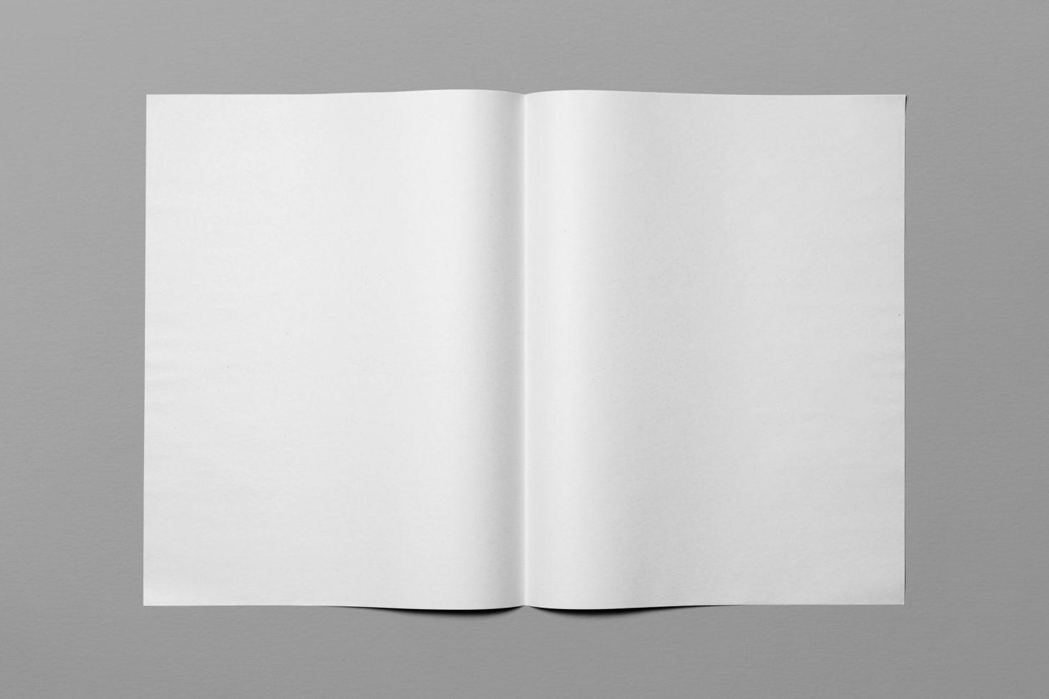 Blank open magazine mockup with white pages on a gray background ideal for design presentations and templates.