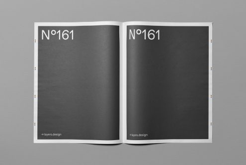 Open magazine mockup on grey background, ideal for presenting editorial designs, with realistic shadows and editable features.