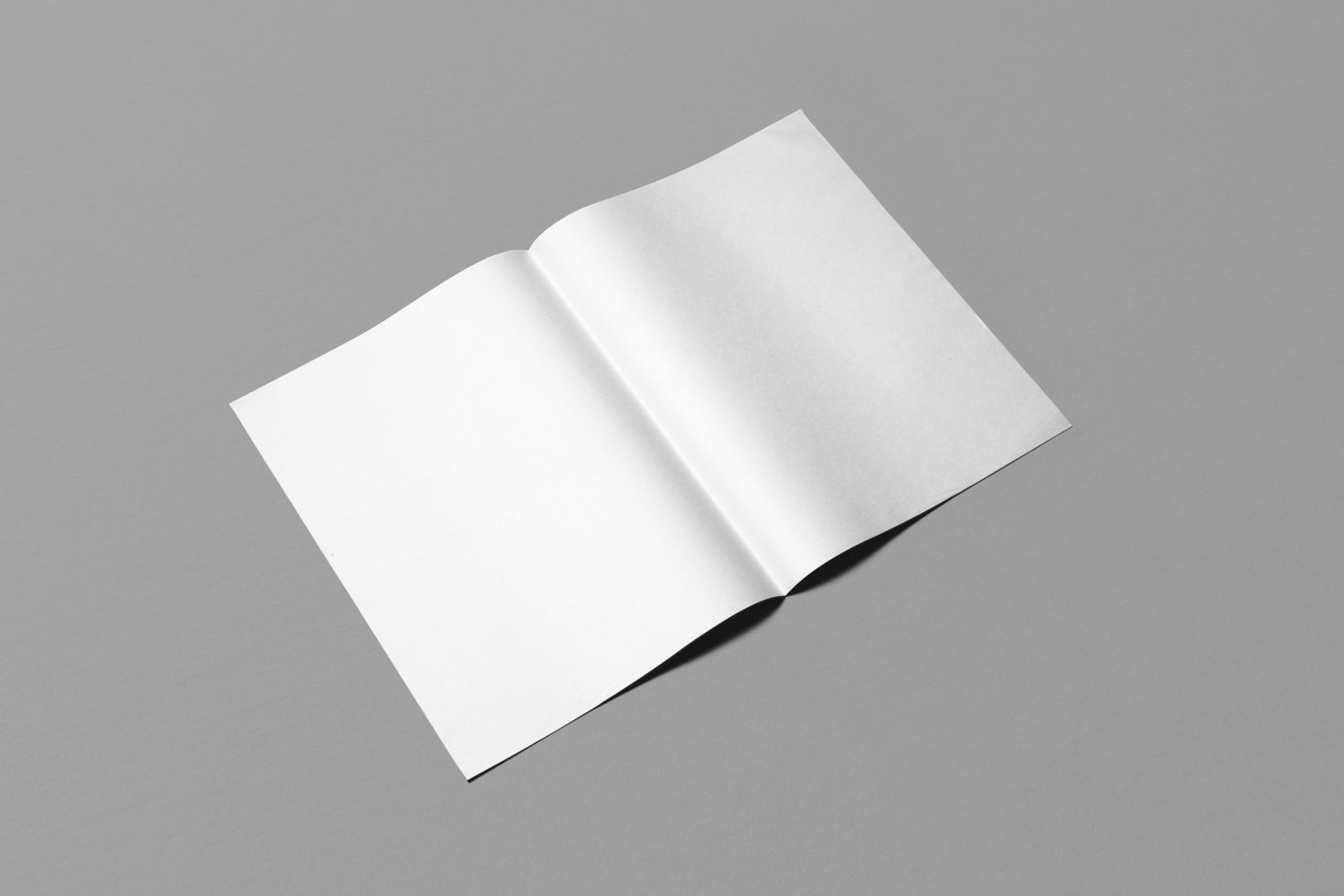 Open blank magazine spread on a gray background suitable for graphic designers to showcase their work in a mockup format.