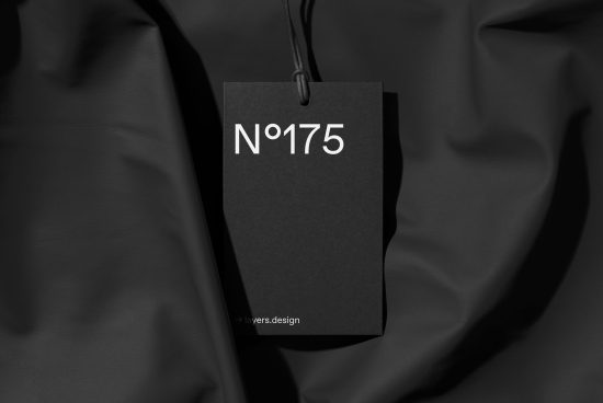Elegant black brand tag mockup on a textured fabric background, ideal for showcasing logo and branding design presentations.