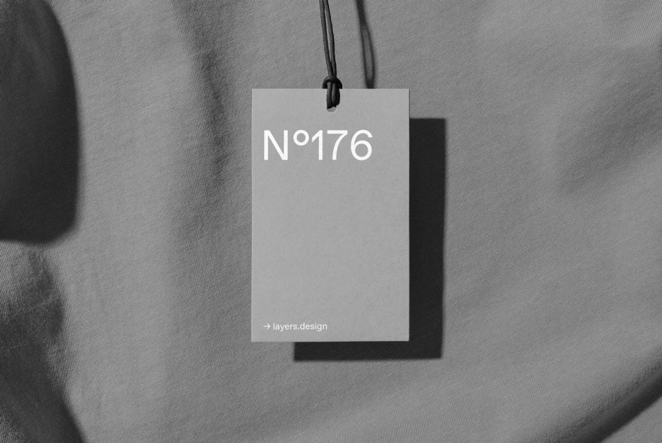 Gray label tag mockup with white card hanging from black string on fabric