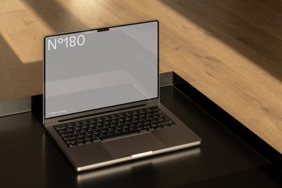 Laptop on wooden surface, minimalist design, modern tech mockup, sleek device display, creative project presentation, digital asset for designers.